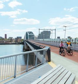 People on bicycles on a bridge 